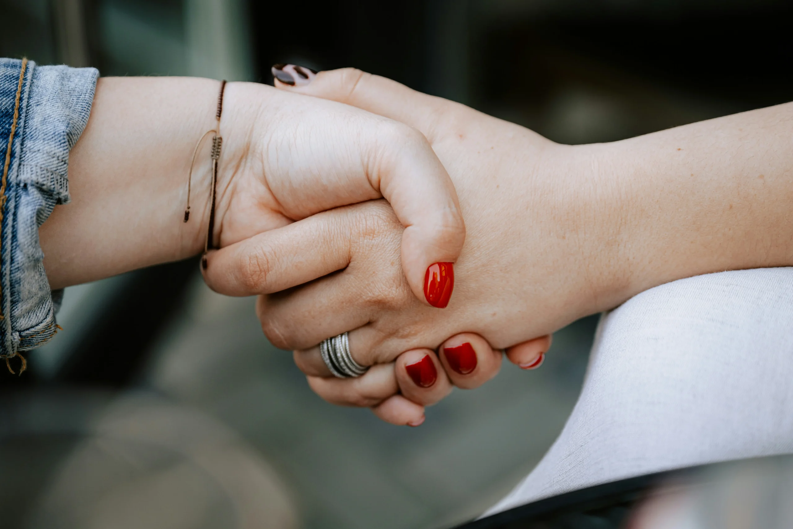 Two empowered women shake hands.